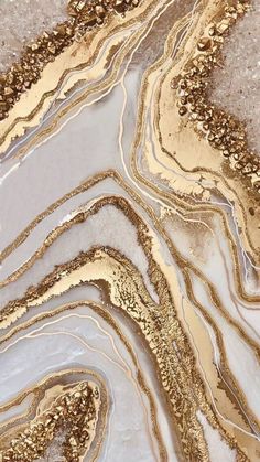 an abstract painting with gold and white paint on top of marbled flooring in a room