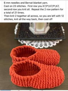 two knitted baby booties sitting on top of a table