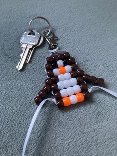 an orange and white beaded christmas tree ornament on a keychain