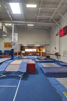 an indoor trampoline gym with blue and red mats