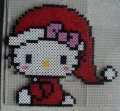 an image of a hello kitty cross stitched on to a piece of fabric with beads