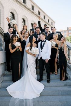 a group of people that are standing on some steps with their arms in the air