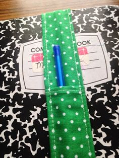 a green and white polka dot tie with a blue pen in it