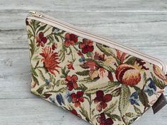 This trendy cosmetic bag is made of tapestry material and is perfect size for make-up, brushes, travel items... Pouch has a soft interlining and closes with a zipper. Enough space to fit keys, cell phone or wallet. Measurements: Width: 8.66 inch / 22 cm Height: 4.72 inch / 12 cm Depth: 3.25 inch / 8 cm Feel free to contact me if you have any questions. Thank you for visiting my shop! Handmade Tapestry Bag For Gift, Charger Case, Small Pouch, Floral Tapestry, Laptop Covers, Small Pouches, Travel Items, Toiletry Storage, Make Up Bag