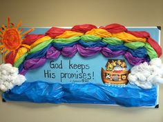 a bulletin board decorated with rainbows, clouds and noah's ark on it