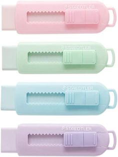 four pastel colored plastic utensils are lined up in a row on a white background