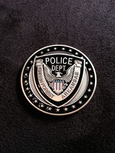 a police badge is shown on a black surface