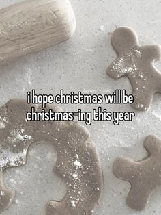 two cookies and a baseball bat sitting on top of a table with the words i hope christmas will be christmas - ing this year