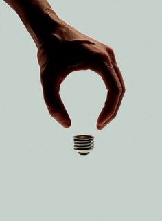 a hand holding a stack of coins in front of a white background with the caption that reads,