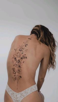 the back of a woman's body with flowers on it