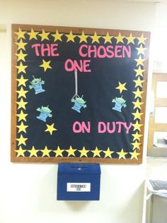 a sign that says the chosen one on duty hanging from a wall in a classroom