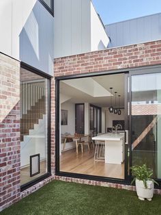 an open living room and dining area with sliding glass doors that lead to the backyard