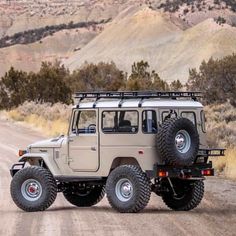 an off - road vehicle driving down a dirt road