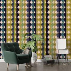 a green chair sitting in front of a wall with geometric designs on it's walls