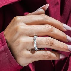 a woman's hand wearing a diamond ring