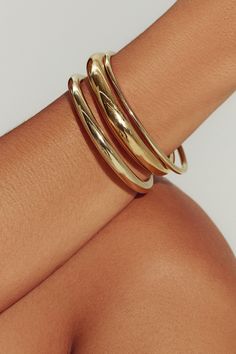 A modern essential, our 18K gold-filled open cuff has the perfect weight and thickness for everyday wear. Layer with our varying widths and finishes for an architectural stack. Jewelry Collection Handcrafted in Brazil 18K Gold Filled Thickness: 5.8mm Inner Diameter: 2.5" Opening: 1.25" Weight: 0.36 oz Waterproof Hypoallergenic Dainty Gold Jewelry Bracelets, Gold Jewelry Brands, Bracelet Layering Ideas Gold, Big Gold Bangles, Chunky Gold Bangle, Gold Bracelet Thick, Gold Jewelry Fashion Bracelet, Gold Waterproof Jewelry, Gold Cuff Necklace