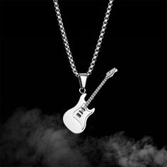 Description & Details The guitar is regarded as a personalized and freely created instrument, and the guitar necklace symbolizes the uniqueness of the individual and the spirit of pursuing freedom. • Material: High Quality Titanium Steel ∙ Cubic Zirconia• Finish: Hypoallergenic ∙ Gold Plating• Dimensions: 55 - 70 cm chain, adjustable• All our work is custom made by hand with love Guitar Necklace, Guitar Pendant, Mini Rock, Black Pendant Necklace, Steel Guitar, Rock Guitar, Classic Guitar, Creative Personality, Estilo Punk