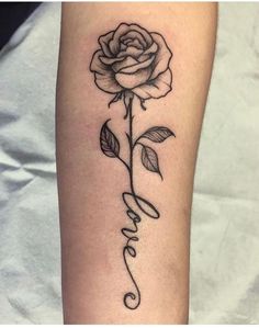 a rose with the word love tattooed on it