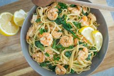 pasta with shrimp, spinach and lemon in a bowl