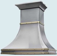 a stainless steel range hood with gold trim