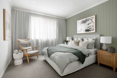 a bedroom with green walls and white bedding