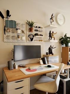 a desk with a computer monitor, keyboard and mouse on it in front of shelves