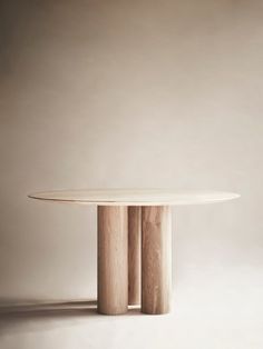 a round wooden table with two columns on it