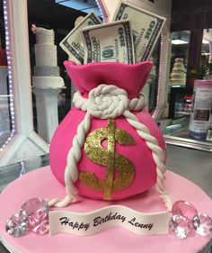 a birthday cake made to look like a pink purse