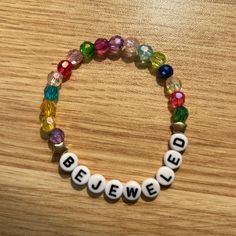 a beaded bracelet with the word bejew spelled in white letters on it