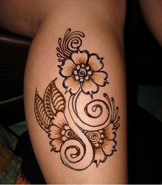 a woman's leg with hendix and flowers on the side, tattoo style