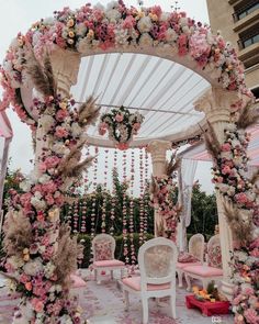 an outdoor wedding setup with pink and white flowers