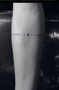 a black and white photo of a person's leg with a cross on it