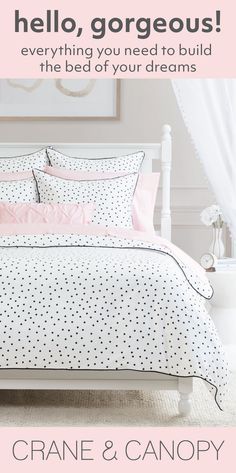 a white bed with pink and black polka dots on it