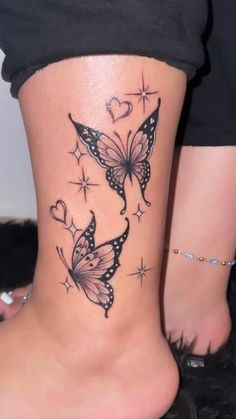 a woman's foot with butterfly tattoos on it