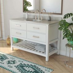 a bathroom with a sink, mirror and rug