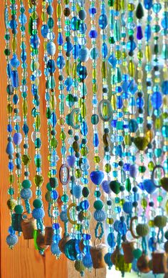 beads hanging from the side of a wooden wall