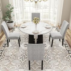 a dining room table with four chairs around it