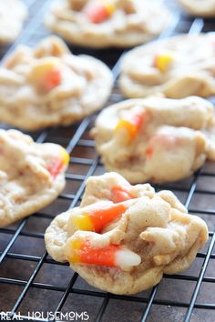 halloween candy cookies cooling on a rack with the frosting and candy in the middle