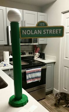 there is a green street sign in the kitchen