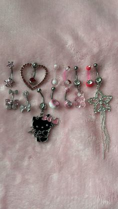 there are many different types of jewelry on the bed together, including earrings and brooches