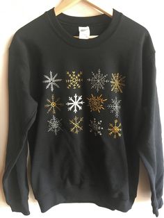 "This Holiday sweatshirt is printed with hand drawn rows of snowflakes. This is a black unisex crewneck sweatshirt printed with metallic gold and silver ink. // PROCESS: All of our items are individually hand printed by either me or my dad, which can lead to slight variations in placement. The ink is heat cured and will not fade over time. Since our items are printed to order, there is a 1-2 week processing time before shipping. If you absolutely need an item shipped quicker than that, please me Gold Long Sleeve Sweatshirt For Winter, Gold Crew Neck Sweatshirt For Fall, Winter Crew Sweatshirt With Screen Print, Please Me, Holiday Sweatshirt, My Dad, Christmas Sweatshirts, Printed Sweatshirts, Metallic Gold