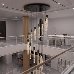 a large chandelier hanging from the ceiling in a living room next to a staircase