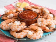 a plate filled with shrimp and dipping sauce