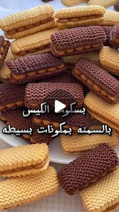 some cookies are on a white plate with words in arabic and an image of waffles