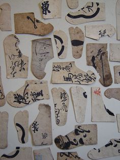 several pieces of paper with writing on them and some type of shoes that are written in different languages