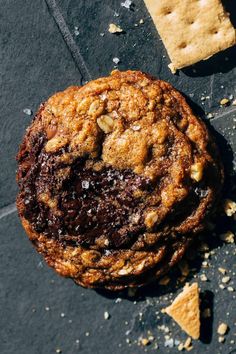 a chocolate chip cookie sitting on top of a table