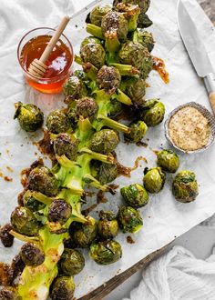 roasted brussel sprouts on parchment paper with dipping sauce