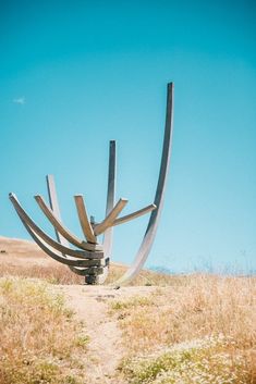 a large metal sculpture in the middle of a field