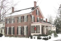 a large red brick house covered in snow