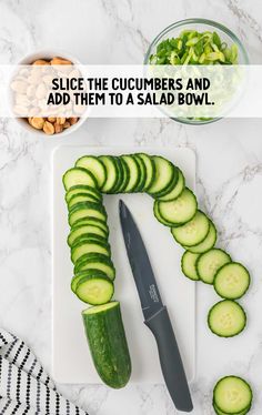 sliced cucumbers and add them to a salad bowl on a cutting board with a knife